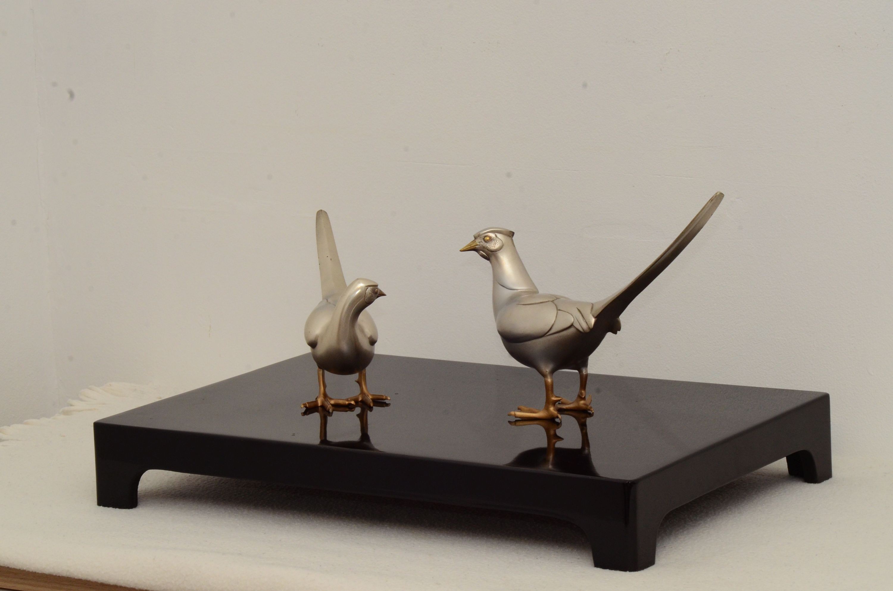 Two 20th century Japanese patinated bronze pheasants with lacquer stand, in original box